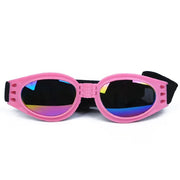 Óculos de sol rosa para cães, dobráveis, com lentes espelhadas coloridas e tira elástica preta.